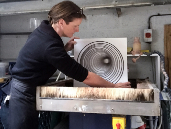 Helen Slater Stokes grinding glass on flatbed