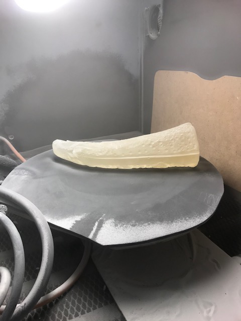 Cast glass in sandblaster.