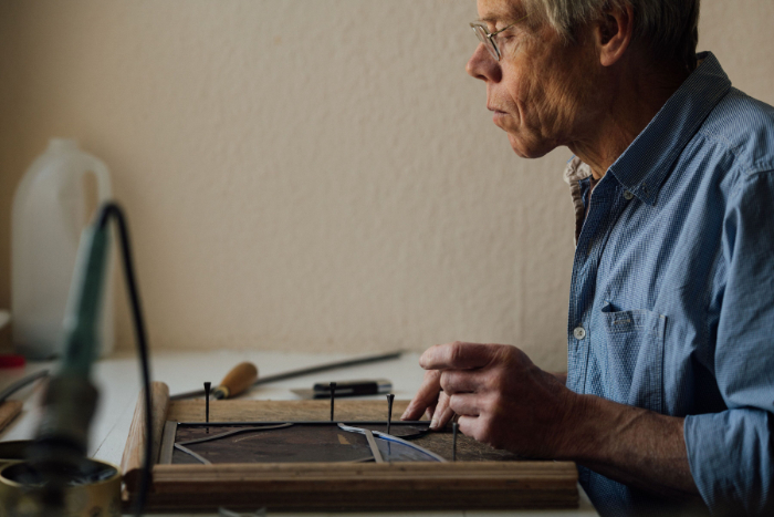 Frans Wesselman working on stained glass.