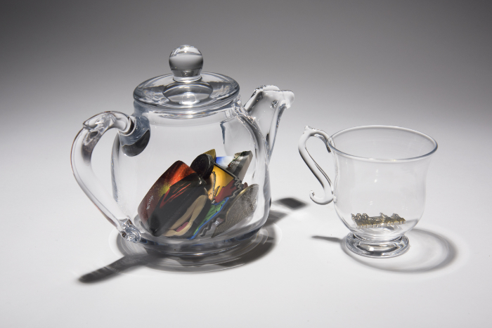 'Idiosyncrasies II' features a blown glass teapot containing fridge magnets and cup in celebration of Emma Baker's grandmother.