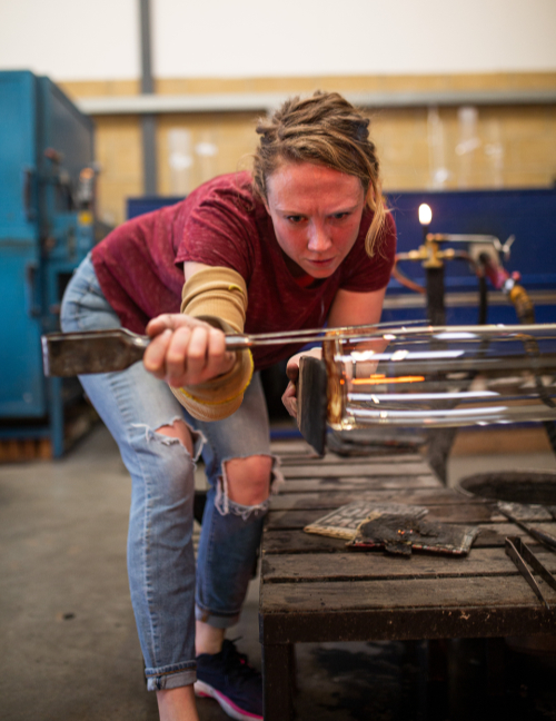Emma Baker working on glassblowing at Devereux and Huskie Glassworks.