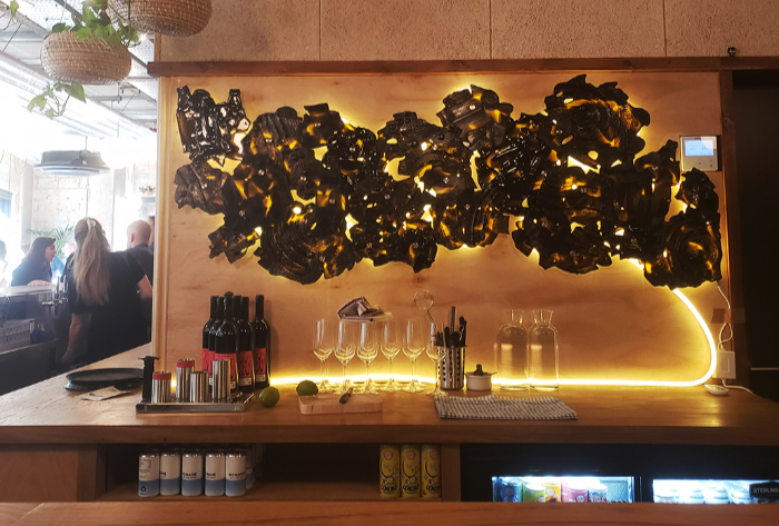 ‘Bottles Deconstructed/Beer in the Making’, uses kiln-formed recycled beer bottles and is located at the Kernel taproom.