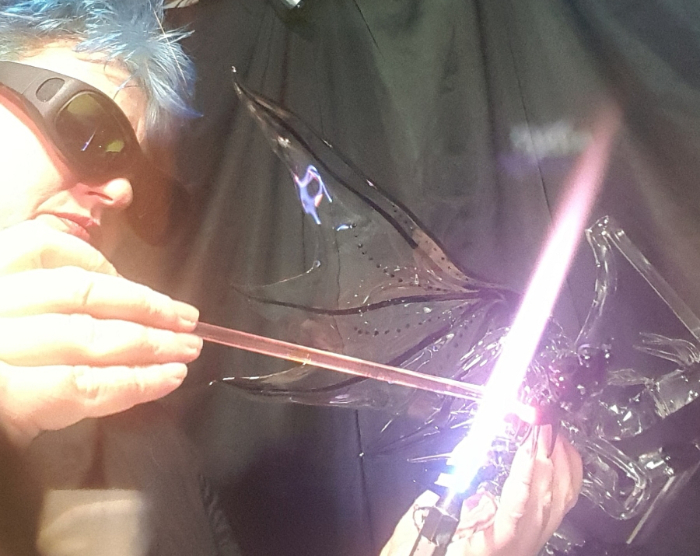 Sandra Young creating a glass dragon at the torch.