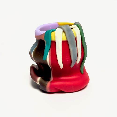 A solid block coloured glass vessel with overhanging glass strips from the collar.