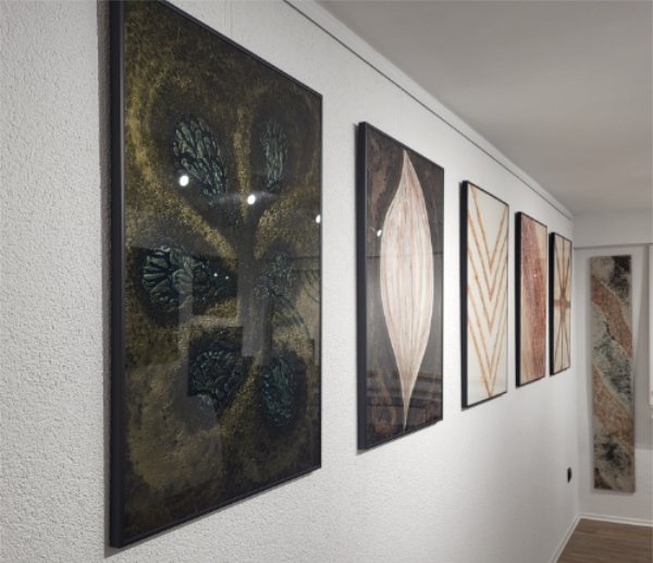 A view of wall art pieces hanging in Carolin Zibulka's studio.