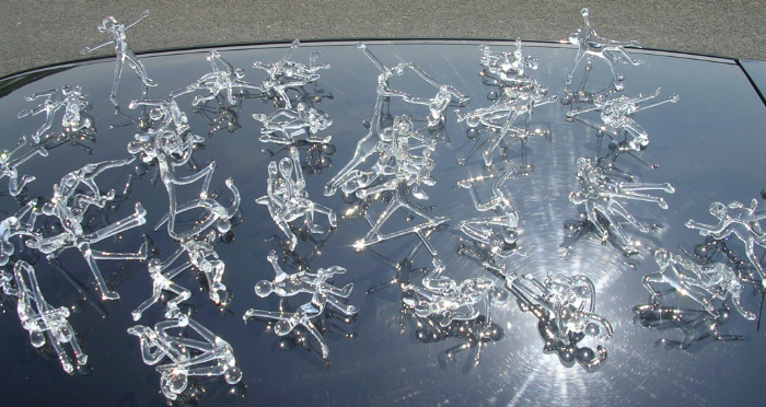 20 pairs of stick figures made from lampworked clear glass.
