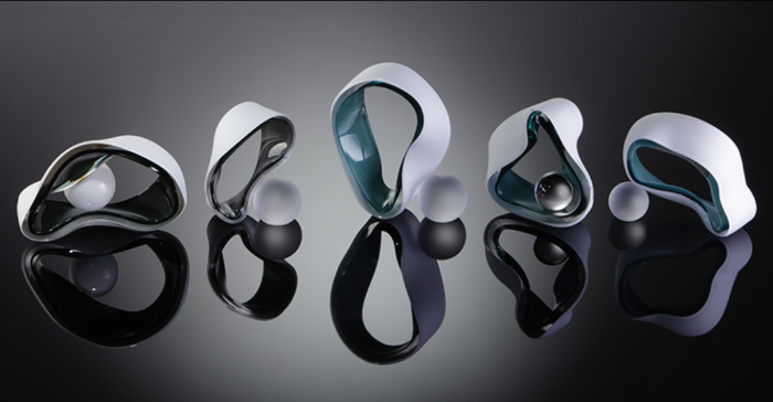 Five pieces of abstract glass sculpture forming Morphology Collection made from ribbon-like distorted circles of white glass with aqua linings and small frosted balls of glass with each one.
